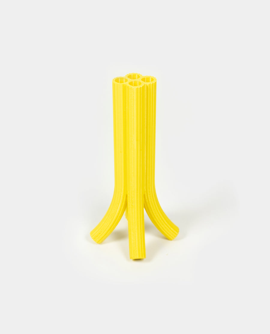 a yellow toothbrush sitting on a white surface 