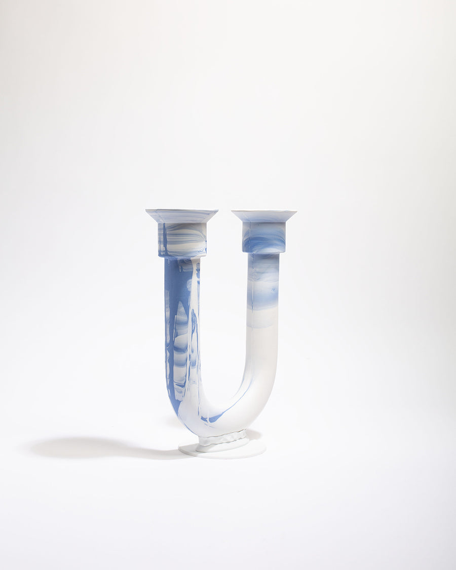 a clear glass vase with a toothbrush in it 