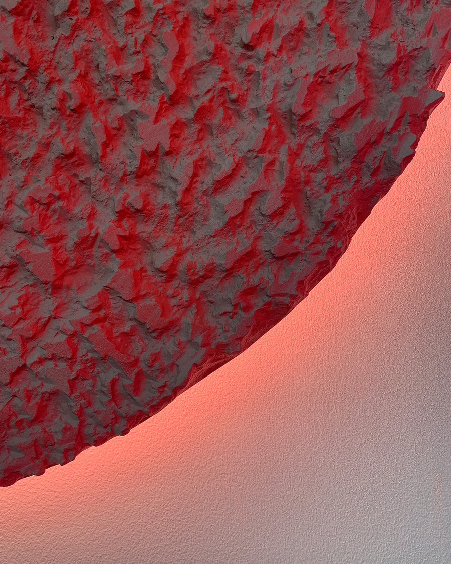 a close up of a red piece of wood 