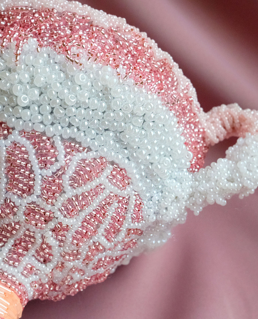 a close up of a pink knitted hat 