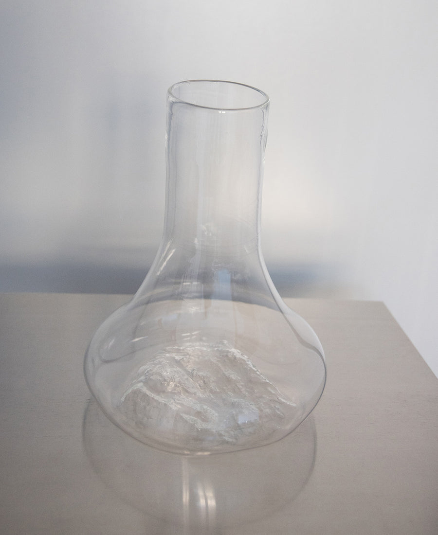 a glass vase filled with water on a table 