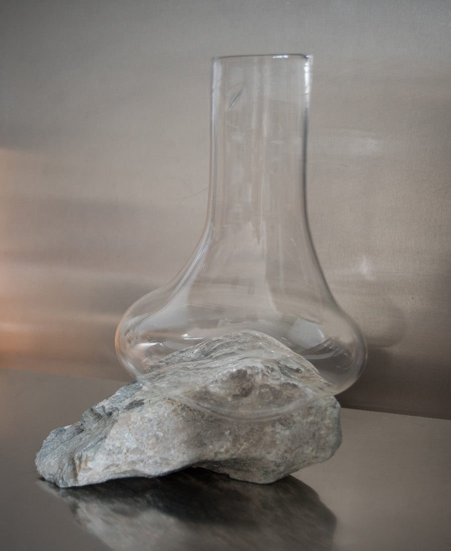 a glass vase sitting on top of a table 