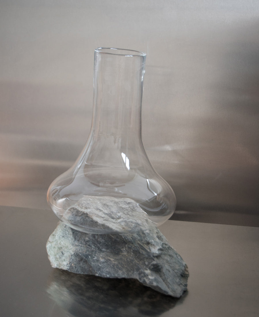 a glass vase with a bottle of water in it 