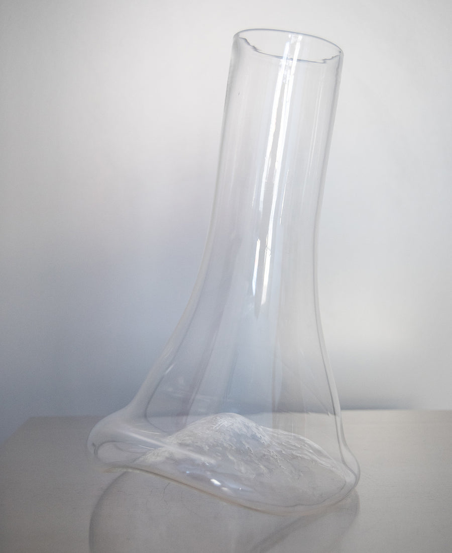 a clear glass vase with a glass of water 