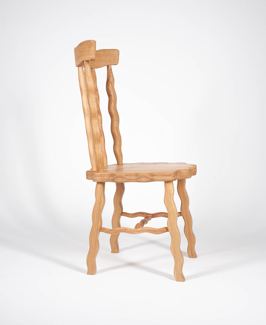 a wooden chair sitting next to a wooden chair 