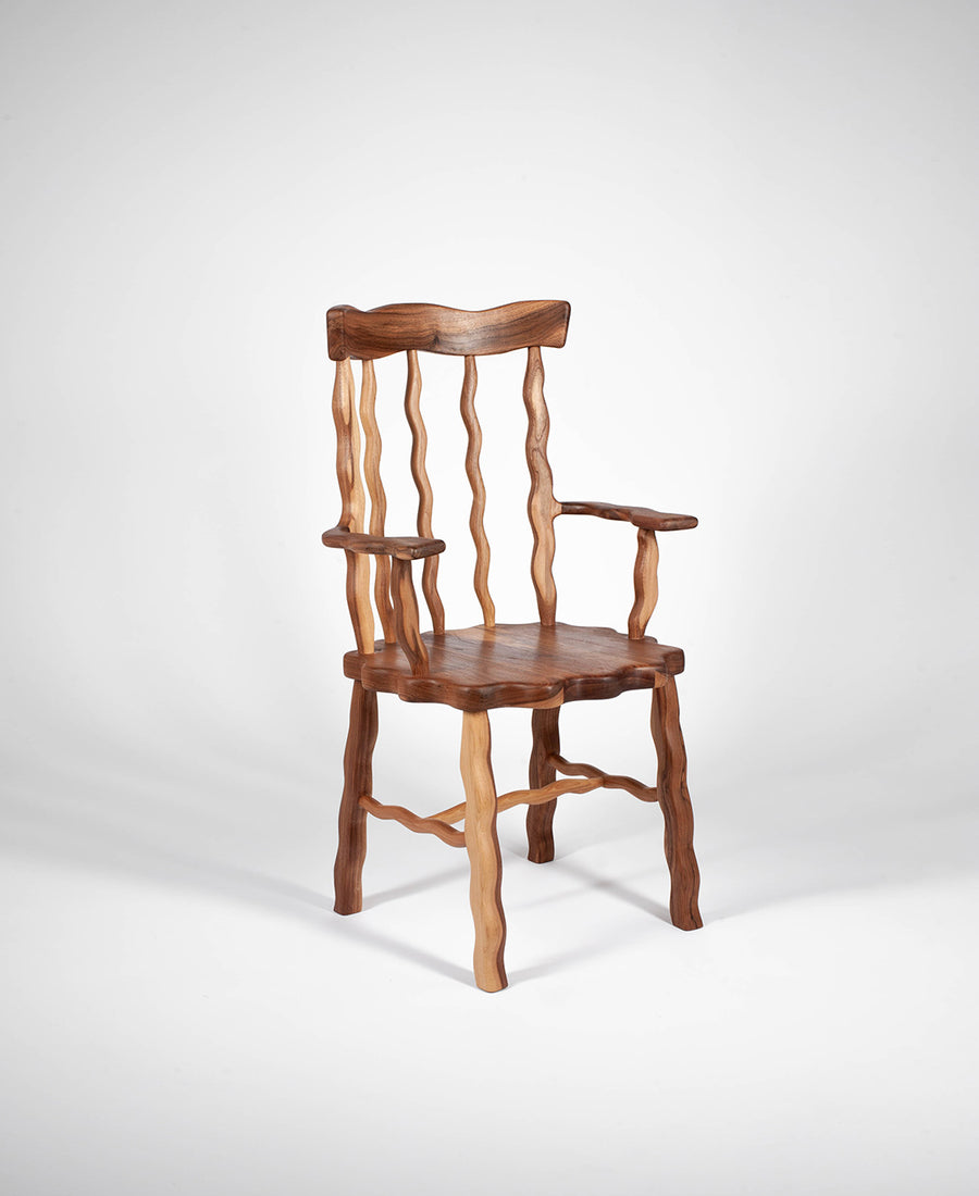 a wooden chair sitting next to a wooden chair 