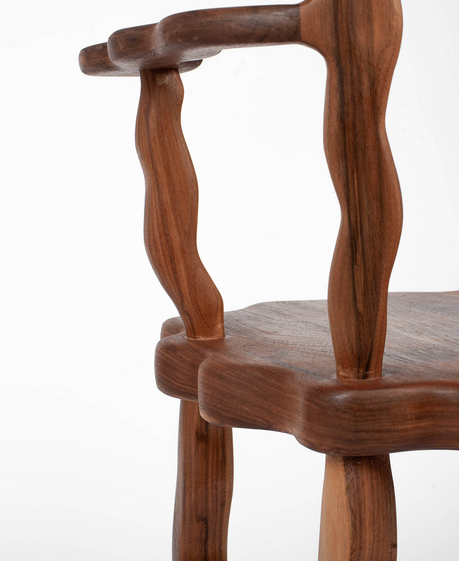 a close up of a wooden chair in a room 